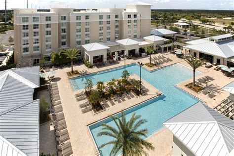 TownePlace Suites Orlando at Flamingo Crossings/Western Entrance Outdoor Pool - Aerial view # ...