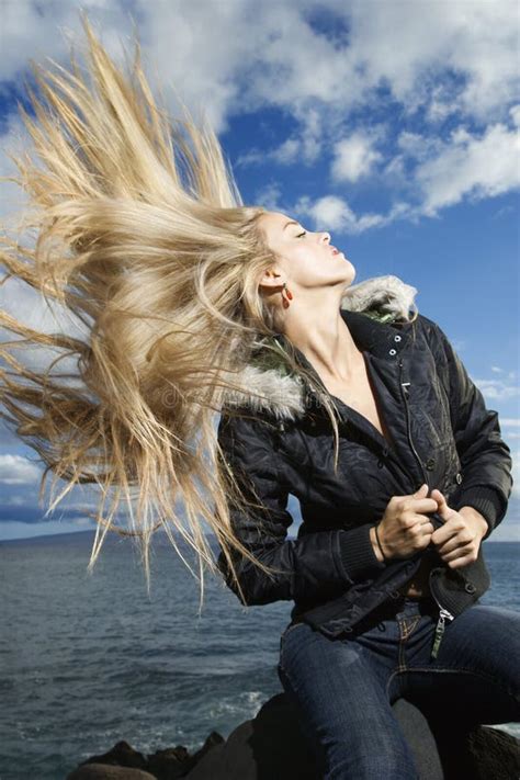 Young Woman Tossing Blond Hair Stock Image - Image: 12747531