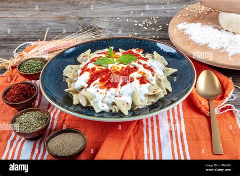 Plates of traditional Turkish food. Turkish Ravioli (Mantı) with yoghurt and tomato sauce Stock ...