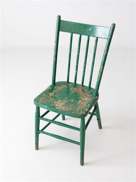 An antique painted wood chair with a spindle back circa early 20th century. Beautifully aged ...