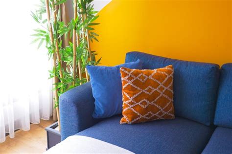 Premium Photo | Blue color modern sofa with pillows in living room at home