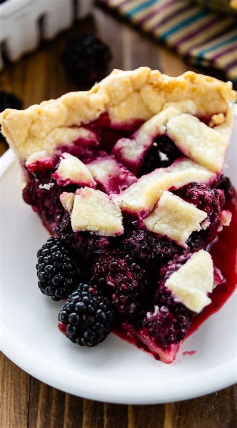 a slice of pie on a plate with berries