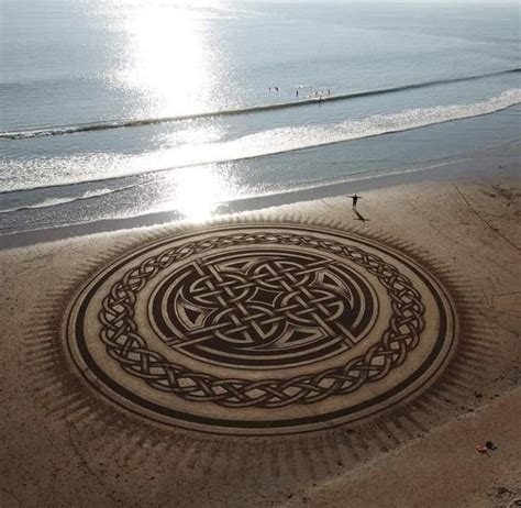 Sand raking art done by one man and a rake at Dollar Bay at Hook Peninsula, Wexford, Ireland ...