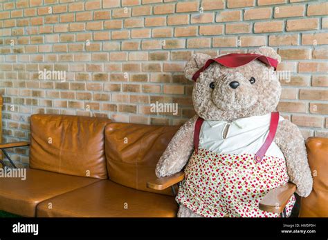 Cute teddy bear sitting on chair Stock Photo - Alamy