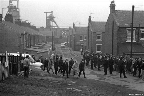 A working miner being escorted through Easington by police. Copyright ...