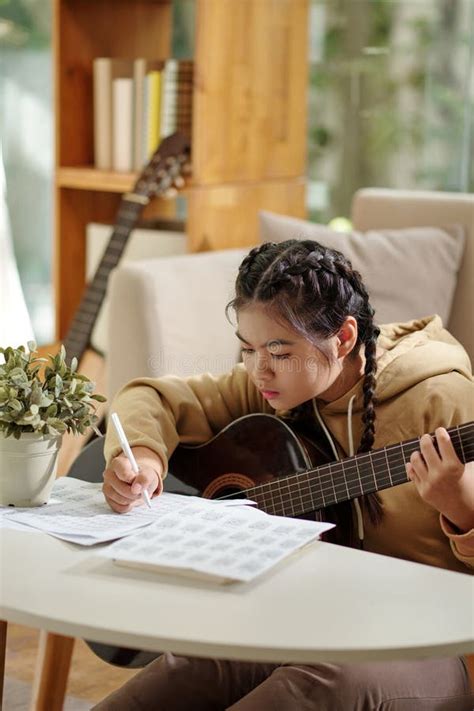 Girl Plucking Guitar stock image. Image of practicing - 274685511