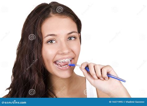 Girl With Braces Brushing Her Teeth Royalty Free Stock Photo - Image: 16571995