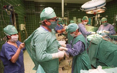 Dr. Zbigniew Religa monitors his patient’s vitals after a 23 hour long ...