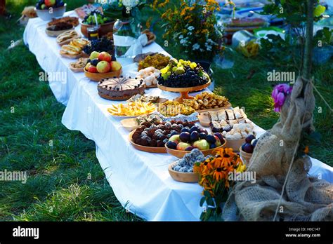 Beautiful wedding feast in nature, abundance of meals on a table Stock Photo - Alamy