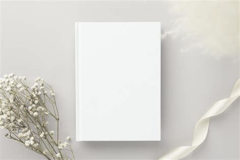 White book blank cover mockup on a beige background with dry flower ...