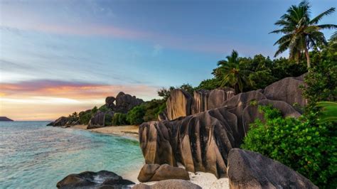 Sunset over rocks at beach Anse Source d'Argent, La Digue Island, Seychelles | Windows Spotlight ...