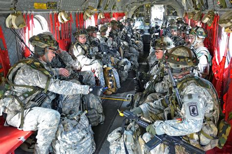 U.S. paratroopers sit inside a CH-47 Chinook helicopter before an air ...