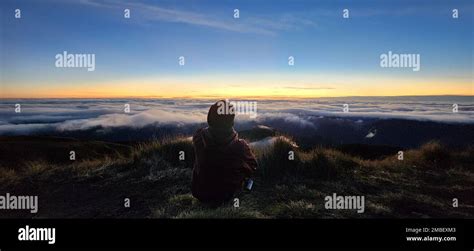 A panorama shot of a person on mount Pulag, watching the stunning view ...