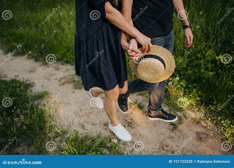 Happy Couple Making Heart Symbol from Hands with Setting Sun in Background at Beautiful Romantic ...