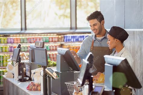 Cashiers working at grocery store checkout - Stock Image - F019/3508 ...