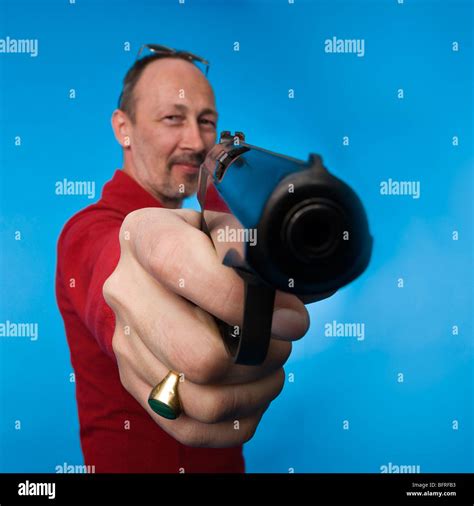 Serious man holding pistol pointing hi-res stock photography and images - Alamy