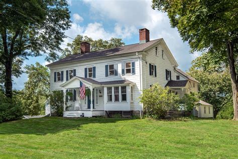 New England farmhouse a classic, outhouse and all