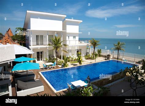 Beautiful villa with a swimming pool by the beach Stock Photo - Alamy