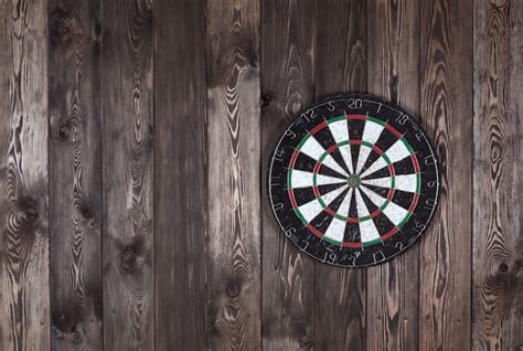 Premium Photo | Dart board on a wooden wall