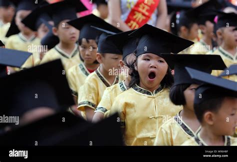 A young Chinese student dressed in a traditional costume and wearing an ...