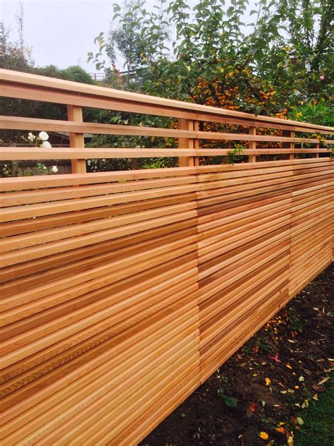 Cedar slatted fencing - the top section has wider gaps to allow more ...