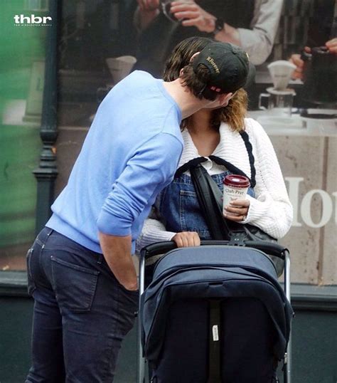 Actor Tom Hiddleston dons iconic Roger Federer cap on day out with fiancee Zawe Ashton and child