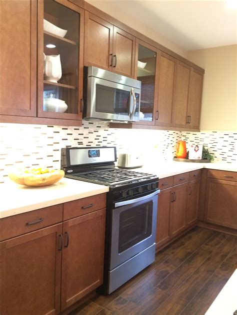 a kitchen with wooden cabinets and stainless steel stove top oven in ...