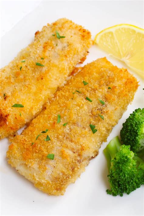 Baked breaded haddock fillets garnished with fresh lemon and served ...