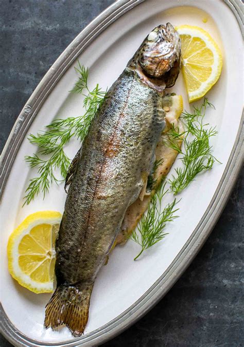 How to grill whole trout, stuffed with lemon, dill, and dotted with butter. Easy! Whole Trout ...