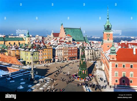 Warsaw old town in winter with Plac Zamkowy (Castle Square), Christmas tree with gifts ...