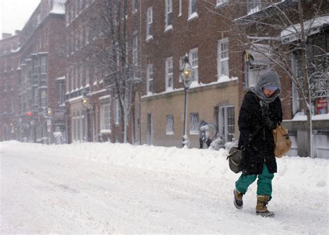 Feb. 9: Woman walks down Charles Street during a severe winter storm