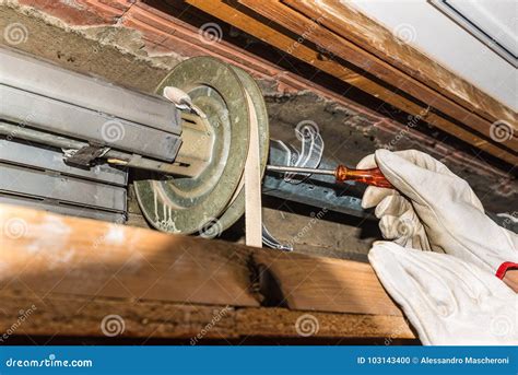 Rolling Shutter Repair. Worker Adjusts a Broken Roller Shutter of a Home. Stock Photo - Image of ...