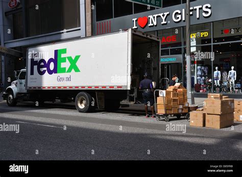 FedEx truck delivery, New York City, USA - driver unloading packages ...