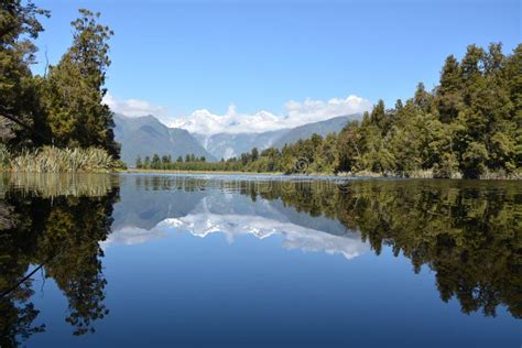 Lake Matheson stock image. Image of trees, blue, water - 57356021