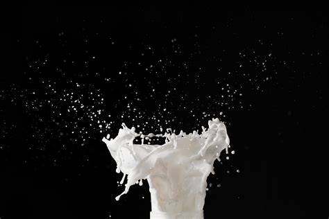 Milk splash on black background 1928250 Stock Photo at Vecteezy