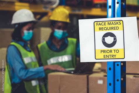 Caution sign in factory warning to industry labor worker to prevent Covid-19 Coronavirus ...