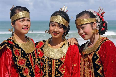 Girls in traditional dress during a ceremony in Afulu. North Nias ...