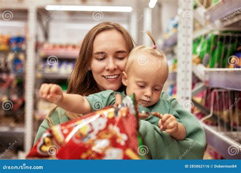 Happy Young Mother with Her Cute Daughter Walking Around Supermarket ...