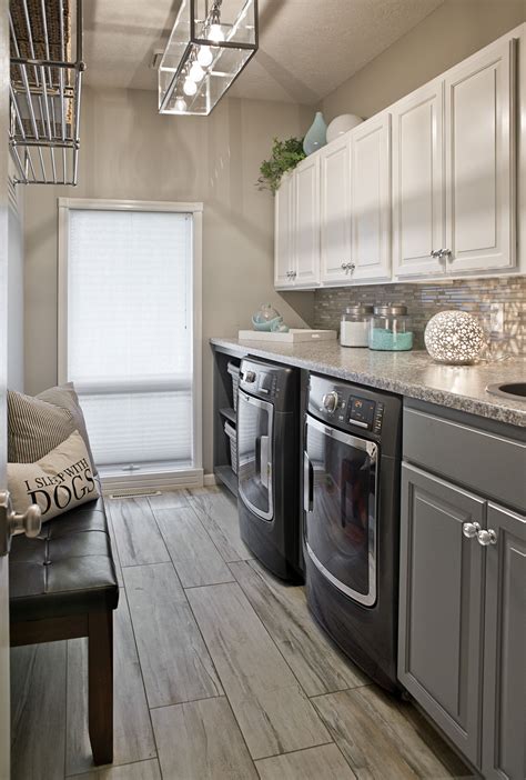 Long Narrow Laundry Room, lots of counter space. Wood look ceramic tile, gauntlet gray cabinets ...