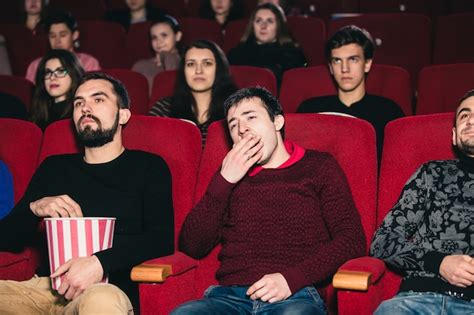 Premium Photo | The guy on the boring movie at the cinema