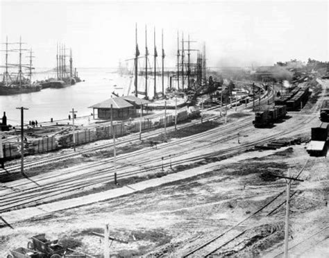 (ca. 1903)#* - San Pedro Harbor docks are filled with tall ships. Lumber is stacked in the ...