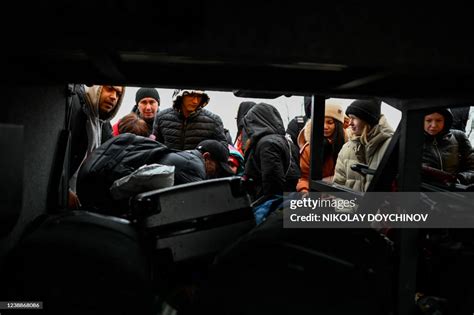 People, who fled Ukraine, board a bus to head to the capital Chisinau... News Photo - Getty Images