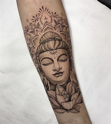 a woman's arm with a buddha tattoo on it