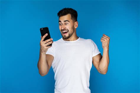 Excited man looking at his smart phone 1822713 Stock Photo at Vecteezy