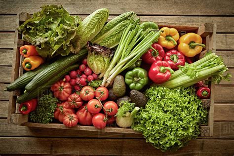 Still life fresh, organic, healthy vegetable harvest variety in wood crate - Stock Photo - Dissolve