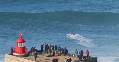 Nazare, Portugal - November 7, 2022 People watching the big giant waves near the Fort of Nazare ...