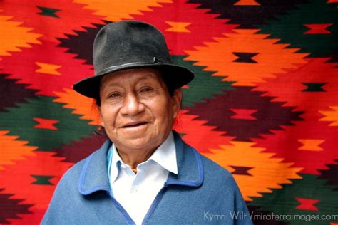South America, Ecuador, Otavalo. A weaver of Peguche stands in front of his work at the Otavalo ...