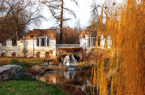 Willow tree (Salix) in a park in warm colors of sunset and ruins — Stock Photo © slava296 #6591368