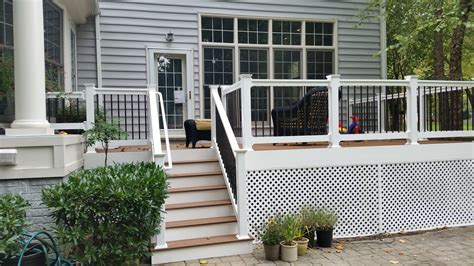 Composite deck w/ white vinyl handrail, white wrap, round black ...