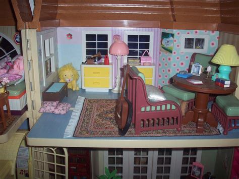 a doll house with furniture and accessories on the top floor in front ...